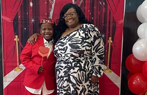 mother and son posing with prompt